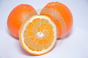 Close-up view of fresh oranges on white background.