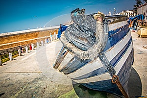 Close up view of the front of an old traditional wooden blue fisherman boat.