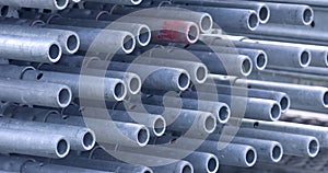 Close up view of galvanized tubing in a stack for construction purpose