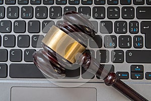 Close up view on gavel and computer keyboard. Internet security laws concept