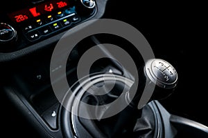 Close up view of a gear lever shift. Manual gearbox. Car interior details. Car transmission. Soft lighting. Abstract view