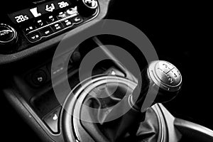 Close up view of a gear lever shift. Manual gearbox. Car interior details. Car transmission. Soft lighting. Abstract view. Black