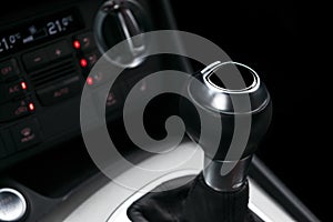 Close up view of a gear lever shift. Manual gearbox. Car interior details. Car transmission. Soft lighting. Abstract view. Car det