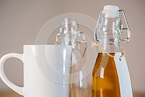 Close up view of glass bottle of apple juice with blank label.