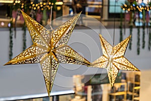 Close-up view of the glowing stars decoration hanging in the shopping mall during celebration Merry Christmas