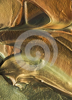 Close-up view of golden paint layered thickly