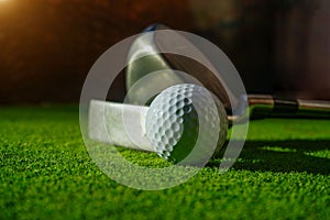 Close-up view of golf ball on the green grass.