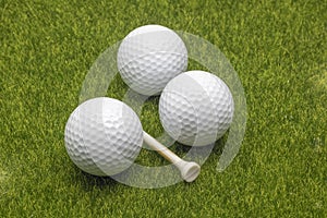 Close up view golf balls and tee on grass background