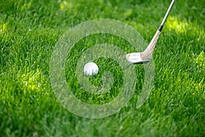 close up view of golf club and ball