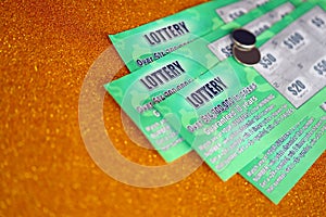 Close up view of green lottery scratch cards. Many used fake instant lottery tickets with gambling results. Gambling addiction