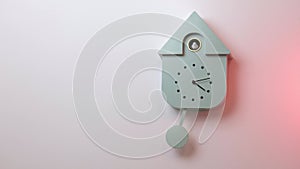 Close up view of grey wall cuckoo clock on colorful background.