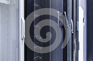 Close up view grid door with key of modern mainframe in high tech internet data center abstract . Depth of field