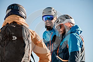 Close-up view on group of men skiers in sunglasses and a ski helmets