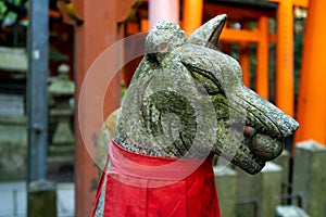 Close-up view of guardian Fox stone statue in Fushimi Inari-Taisha Shinto Shrine in Kyoto, Japan.