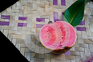 close up view of guava fruit isolated on black background as copy space.
