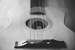 Close up view of a guitar laying down on a table