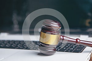 Close up view of a hammer and a computer keyboard