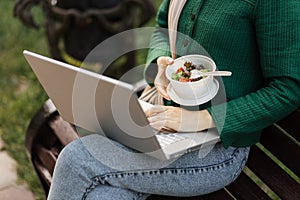 Close up view of hand of businesswoman having a vegetables salad for lunch