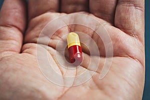 close-up view of a hand a pill
