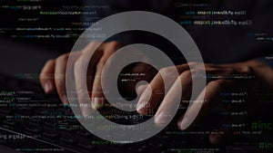 Close-up of Hands Typing on Keyboard with Overlay of Programming Code in Dark Environment for Technology and Software