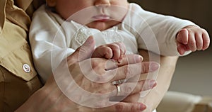 Close up view hands of mother and newborn