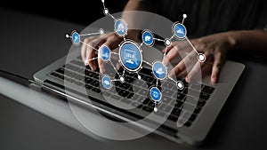 Hands typing on laptop keyboard with digital communication icons representing technology, connectivity, and networking