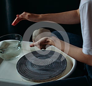 hands working on a potter& x27;s wheel