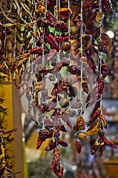 The Close up view of hanging hot dried chili peppers on the local farmers market Mercado dos Lavradores in Funchal