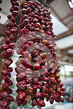 The Close up view of hanging hot dried chili peppers on the local farmers market Mercado dos Lavradores in Funchal