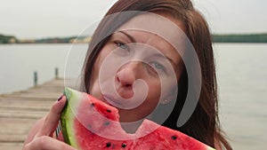 Close up view of happy smiling woman eating tasty watermelon.