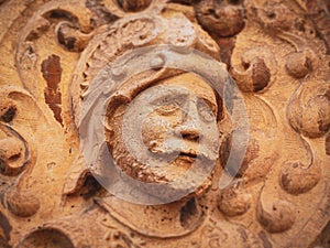 Close-up view of the head of a sculpture of a warrior caved on a rocky wall