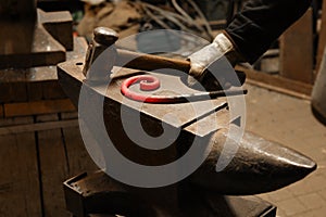 Close up view of heated metal and anvil. The blacksmith in the production process of metal products handmade in the