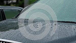 Close up view of heavy rain water drops storm rain falls on the car window