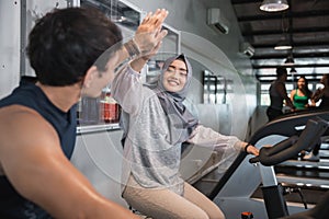 Close up view high five at the gym doing cardio exercises