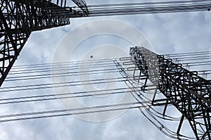 Close up view , high voltage power lines station. High voltage electric transmission pylon silhouetted tower