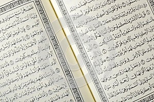 Close up view of Holy Al Quran with written in arabic calligraphy