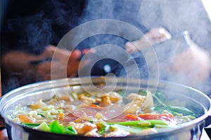 Close up view of hot pot with meat beef sliced and vegetables. Shabu Shabu is style beef in hot pot dish of thinly sliced meat and
