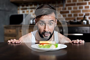 close-up view of hungry bearded young man