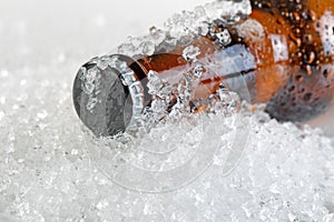 Close up view of an ice cold beer bottle neck and cap