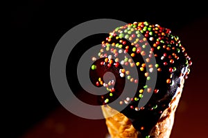 Close up view of ice cream with chocolate topping and sugar decoration balls