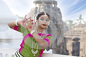 Close up view of indian classical odissi dancer posing at Lingaraja temple. Indian culture and tradition.