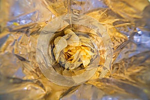 Close-up view inside of a big silver bag of potato chips with selective focus