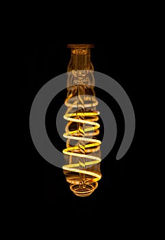 Close up view inside spiral LED decorative light bulb at dark.