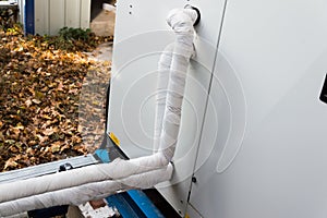 Close-up view of the insulated refrigerant pipelines connected to the air handling unit