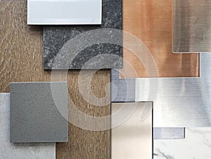 close up view of interior material samples including wood veneer, ceramic tiles, multi color of aluminium metallics, travertine