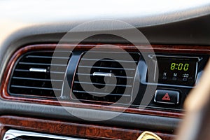A close-up view of the interior of a modern luxury car with a ventilation deflector for heating and cooling the passenger