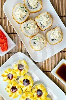 Close-up view of Japanese sushi roll with tempura shrimp. Deep-fried vertical photo. for two persons