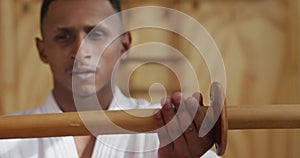 Close up view judoka holding a wooden saber