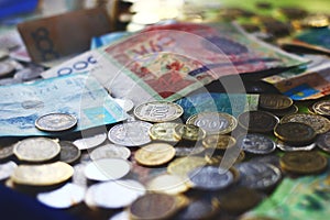 Close up view on kazakh and kyrgyz currencies banknotes and coins