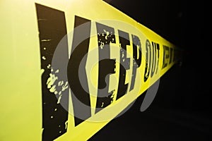 Close-up view of keep out tape against dark background